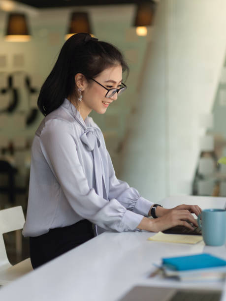 istock Female office worker working with office supplies in modern office room 1292532253