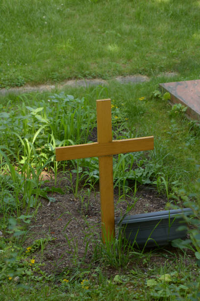 istock unknown grave with wooden cross no name 1292532853
