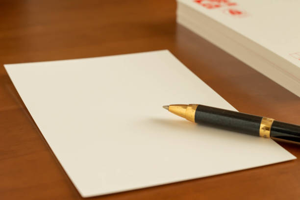 New Year's card and ballpoint pen placed on the desk stock photo
