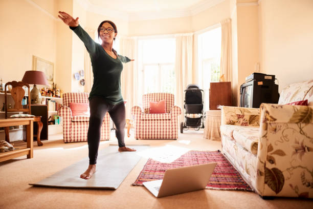 istock Woman exercising during an online yoga class 1292533012