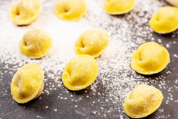 istock The dark marble background is strewn with white flour and lined with dumplings 1292533146