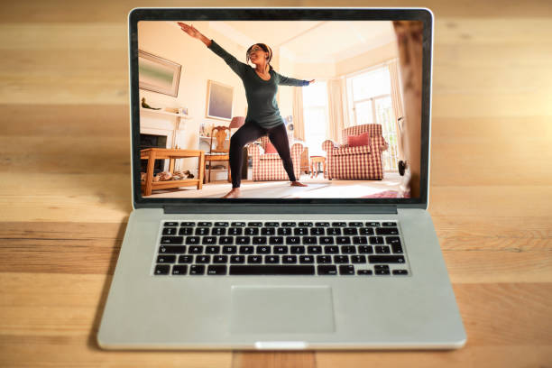istock Young woman practicing yoga on a laptop display 1292533161