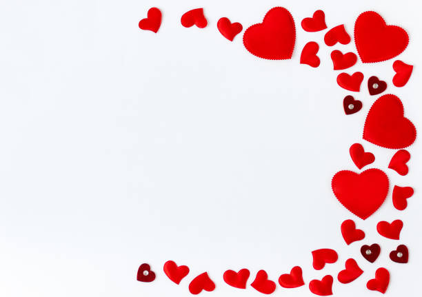 istock Frame of red hearts with space for text the centre on white background. Flat lay, top view Valentines Day background love concept. 1292533875