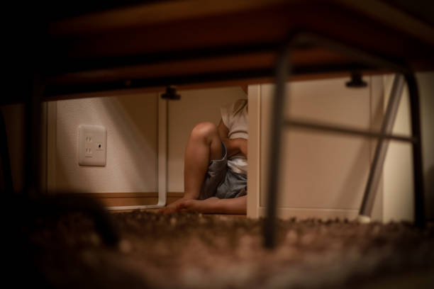 istock Boy hiding under the desk 1292534119