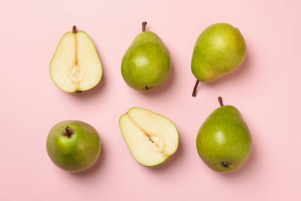 istock Fresh green pears on pink background, top view 1292536359