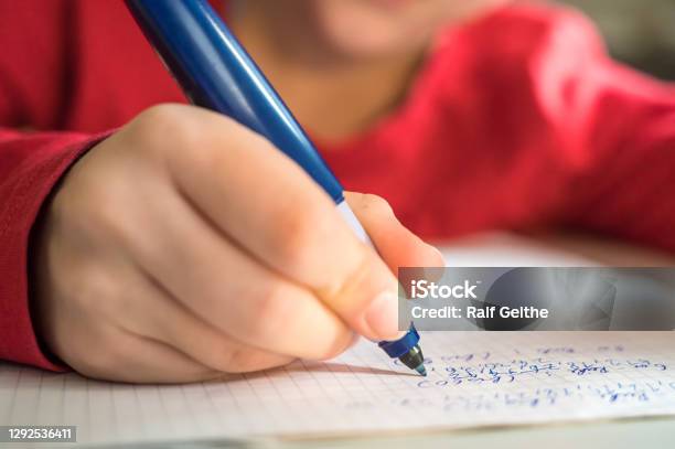 Elementary School Age Child Practices Arithmetic While Solving Math Problems Stock Photo - Download Image Now