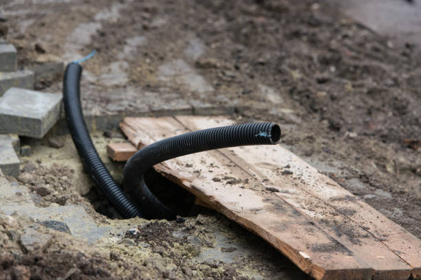 istock Thin diameter ribbed black PVC pipe in the ground before laying 1292537706