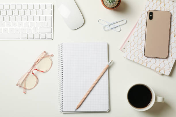 istock Concept of female workplace with modern keyboard on white table 1292537912