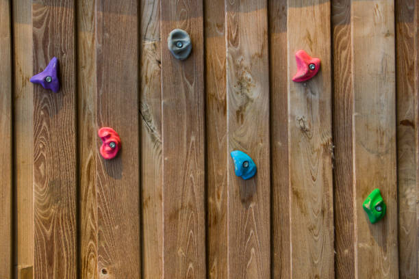istock Climbing wall close-up, wooden material and hanging rocks 1292540047