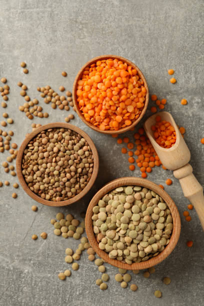 istock Scoop and bowls with different legumes on gray background 1292540337