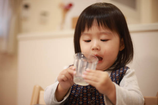 istock Girl drinking juice with a glass 1292542415