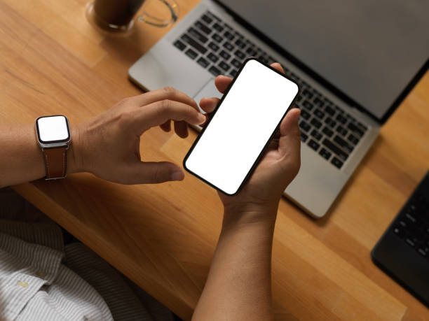 istock Businessman using smartphone on worktable with laptop in home office room 1292542536