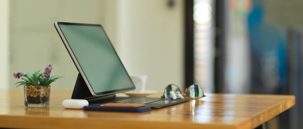 istock Portable workspace with digital tablet, eyeglasses, accessories and plant pot 1292545002