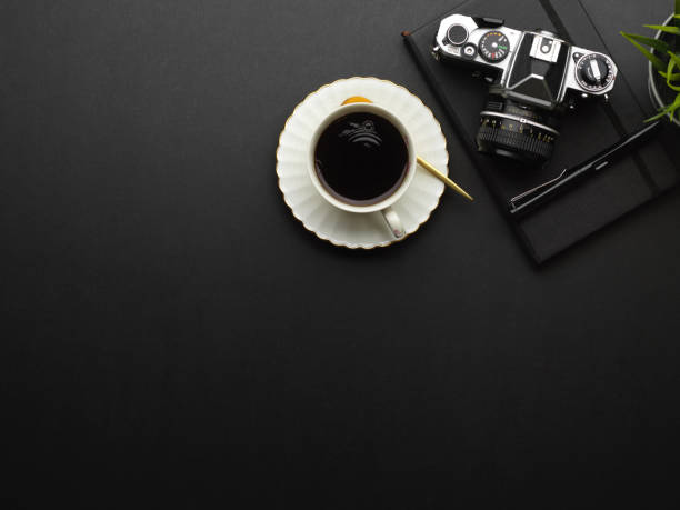 istock Top view of workspace with coffee cup, camera, notebook and copy space 1292545059