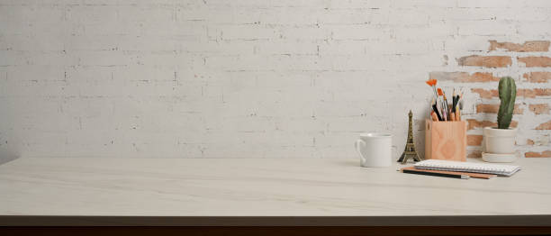 istock Worktable with copy space, stationery, cactus pot in home office room 1292545070