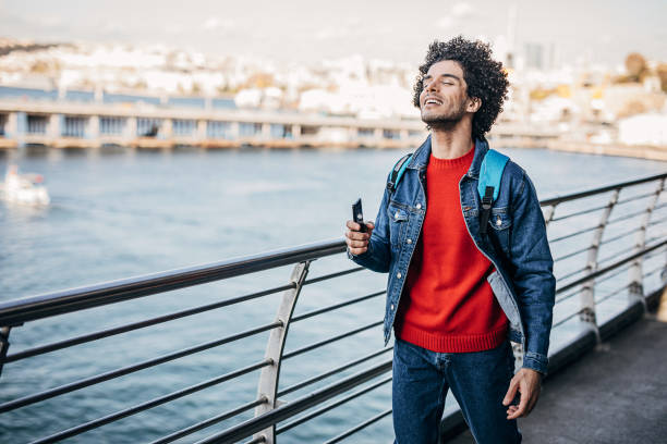 istock Handsome man walking by the sea 1292545255