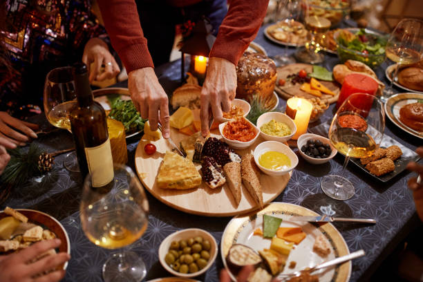 istock Man Serving Food At Christmas Dinner At Home 1292545512