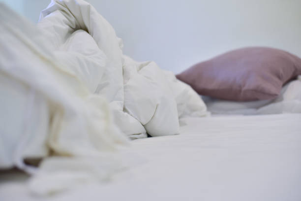 istock Blurred brown pillow on wihte bedroom. 1292546311
