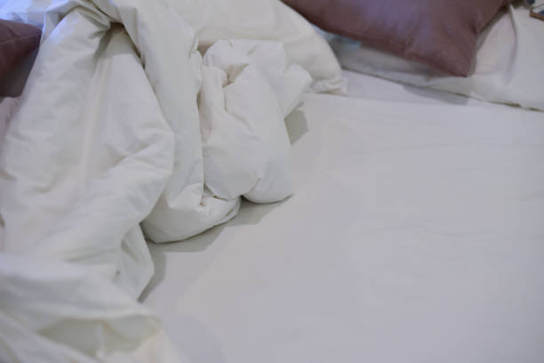 istock Blurred brown pillow on wihte bedroom. 1292546398