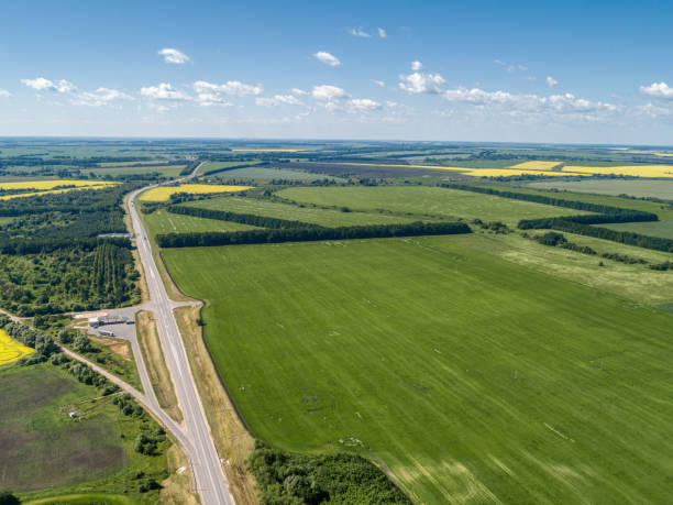 istock The motorway runs through green fields. Aerial view 1292546549