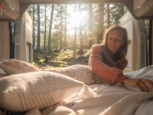 istock Woman makes bed at the back of her van 1292549722