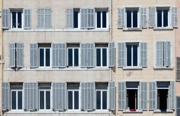 istock typical facade of an old hotel with open and closed shutters 1292549976