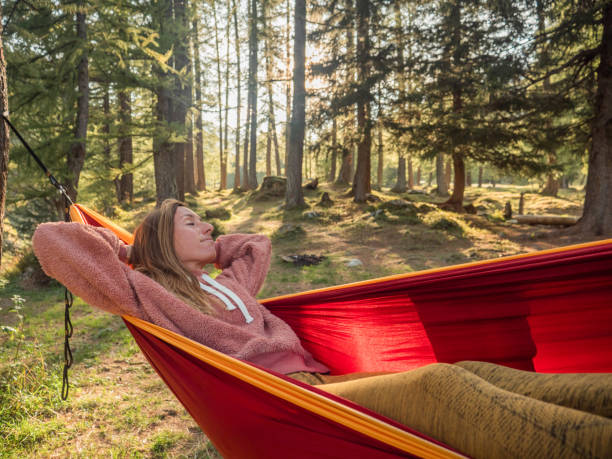 istock Woman relaxes in hammock at sunset 1292550023