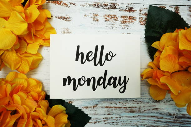 istock Hello Monday Card with Blooming flower on wooden background 1292552370