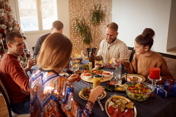 istock Friends Enjoying Christmas Dinner At Home 1292553558