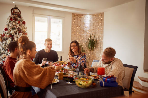 istock Friends Enjoying Christmas Dinner At Home 1292553573