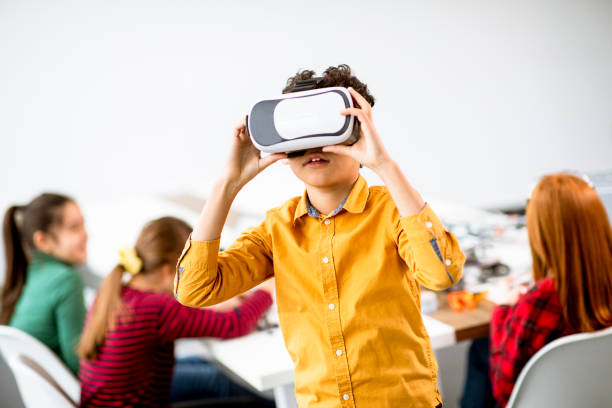 istock Cute little boy wearing VR virtual reality glasses 1292554672