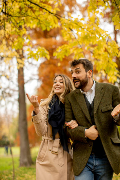 istock Young couple walking in the autumn park 1292555115
