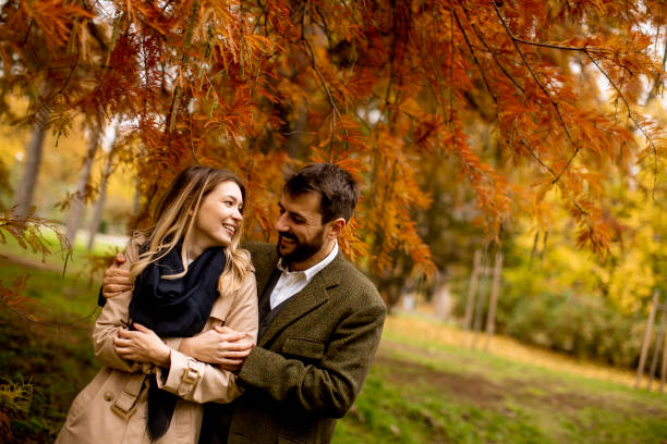 istock Young couple in the autumn park 1292555128
