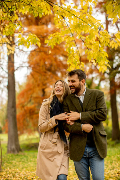 istock Young couple walking in the autumn park 1292555142