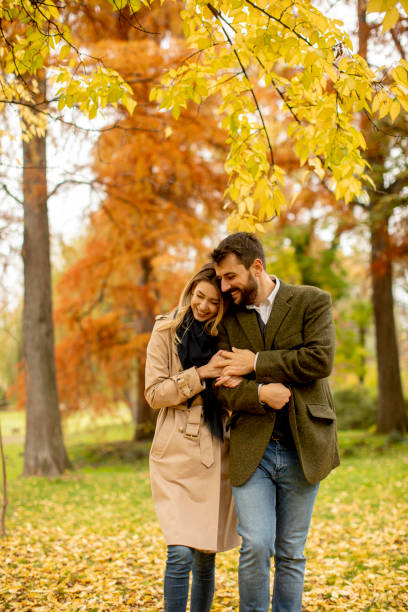 istock Young couple walking in the autumn park 1292555168