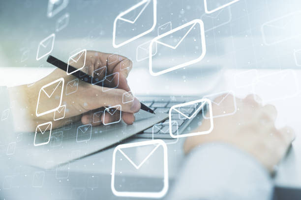 istock Creative concept of postal envelopes illustration with hand writing in notebook on background with laptop. Email and communications concept. Multiexposure 1292556136