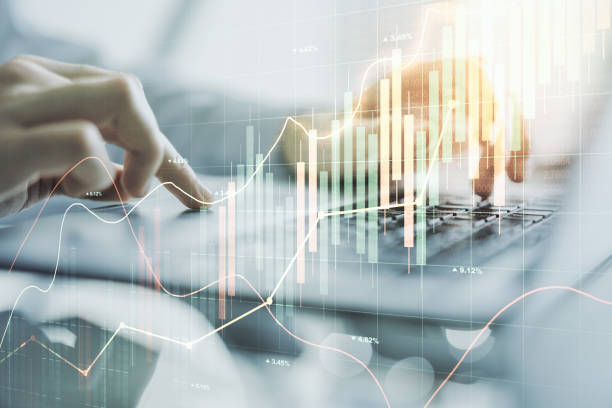 istock Abstract creative financial graph with hand typing on laptop on background, forex and investment concept. Multiexposure 1292556290