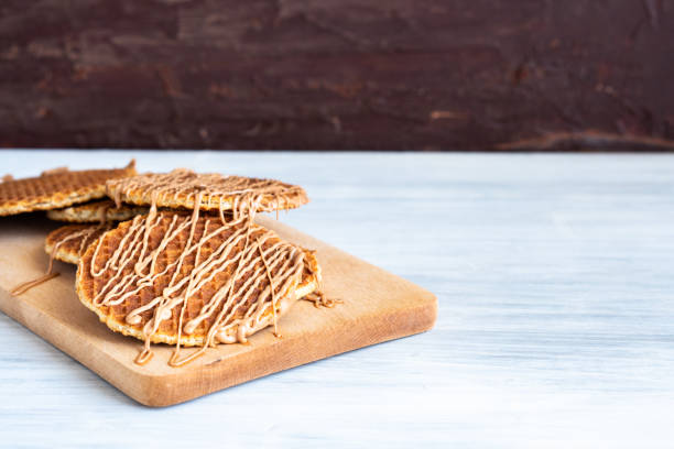 signature authentic Dutch Netherlands sweet dessert waffle caramel honey sugar syrup for coffee tea call Stroopwafel tradicional local auténtico holandés auténtico dulce fresco casero sabroso pila marrón dorado waffle derretir jarabe de miel de caramelo salado para el postre en la cafetería con té caliente de leche caliente caliente y caliente llamada stroopwafel