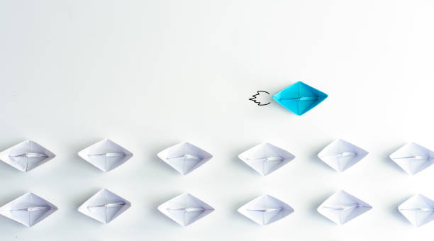 istock Blue paper ship are different from others on white background. Business for Innovative, solution and different vision concepts. 1292558948
