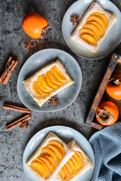 Persimmon puff pastry pies with cinnamon