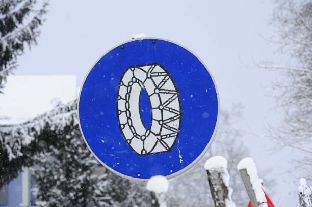snow chain obligation traffic sign in the mountains in winter