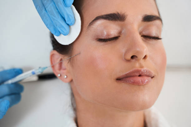 istock Lady during procedure in cosmetology clinic 1292562315
