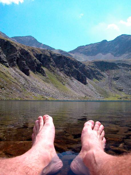 istock mountain stream and feet in the alps 1292562391