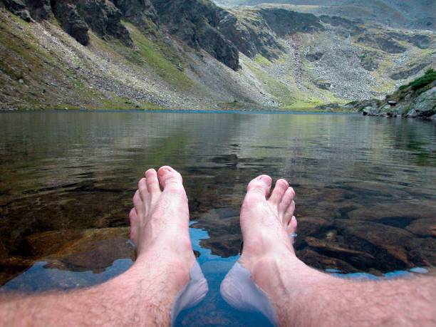 istock mountain stream and feet in the alps 1292562406