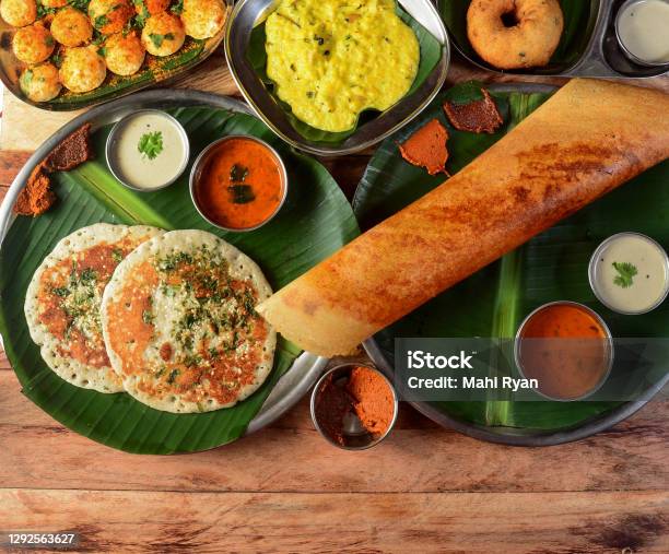 Assorted South Indian Breakfast Foods On Wooden Background Ghee Dosa Uttappammedhu Vadapongalpodi Idly And Chutney Dishes And Appetizers Of Indian Cuisine Stock Photo - Download Image Now