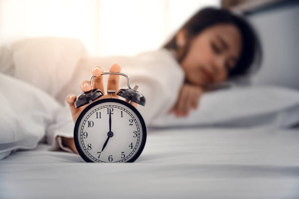 istock Close-up Hand turns off the alarm clock waking up at morning. 1292564549