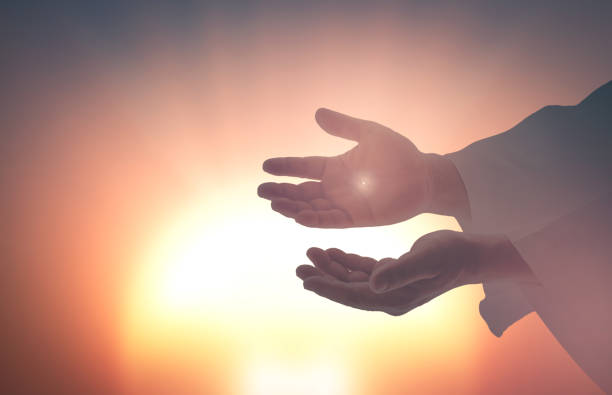 Jesus Christ hands showing scars Ascension day concept: Jesus Christ hands showing scars for Thomas over blurred sunset background jesus christ stock pictures, royalty-free photos & images
