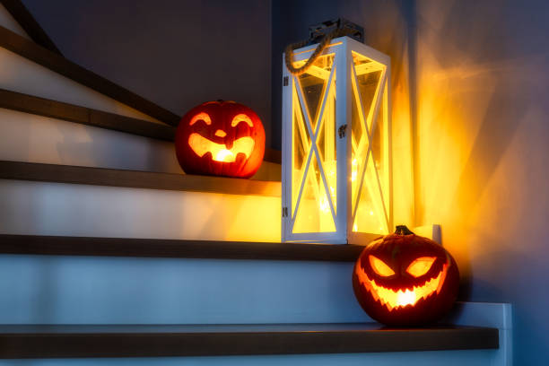 istock Scary Halloween pumpkins in face masks glowing 1292569100