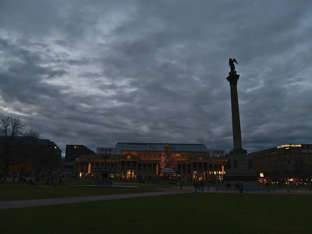 popular square schlossplatz in downtown in evening with the silhouette of jubiläumssäule and historic building königsbau during christmas season with decorations. - museum monument silhouette tree imagens e fotografias de stock