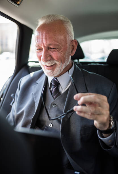 istock An older businessman in an elegant suit is having a business conversation using laptop 1292570382